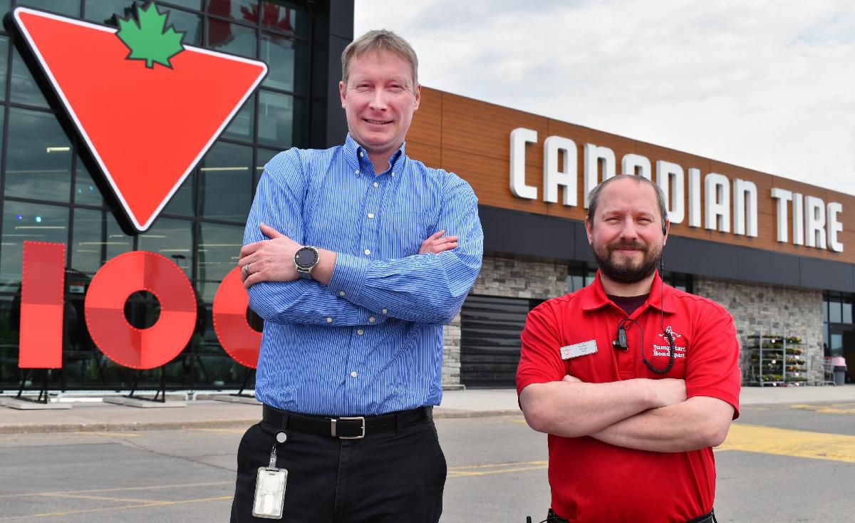 image of General manger Kevin Ryder and senior manager Richard King stand in front of the Welland Canadian Tire. 