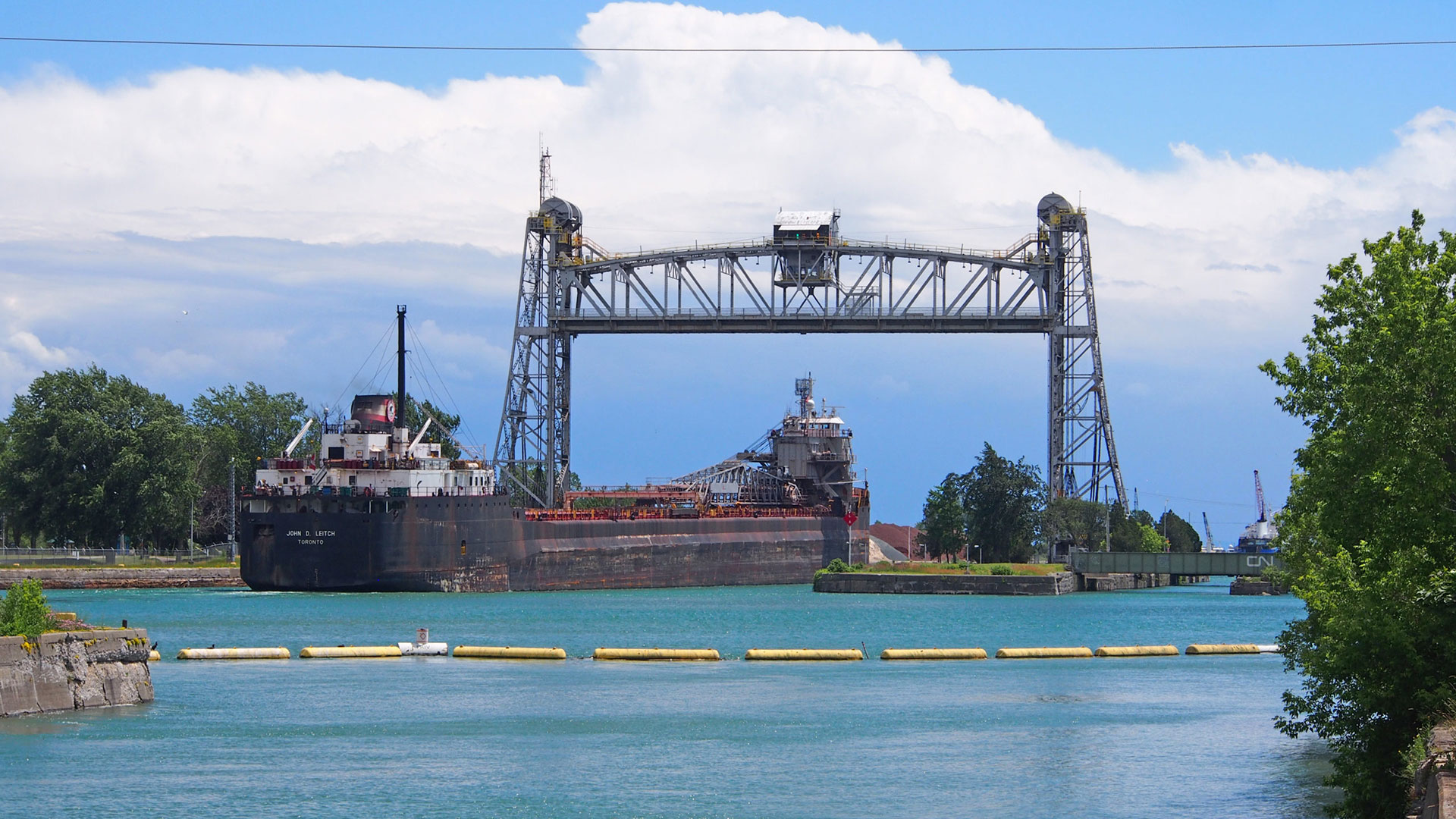 Port Colborne canal bridge is raised, with a ship passing through