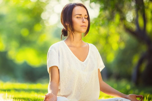 woman meditating outdoors  